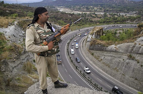 A paramilitary soldier stands guard as the first batch of pilgrims leaves for Amarnath Yatra in Jammu on Wednesday June 27 2018. ( Photo | PTI)