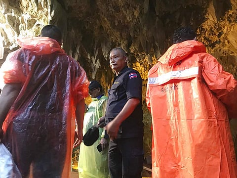 Rescue workers gather at the entrance of a cave in Mae Sai, Chiang Rai province, northern Thailand. ( Photo |  AP )