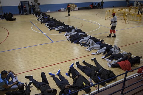Migrants sleep at a makeshift emergency center for migrants at Barbate's municipal sports center, in the south of Spain, after being rescued by Spain's Maritime Rescue Service in the Strait of Gibraltar, Wednesday, June 27, 2018. Authorities in Southern S