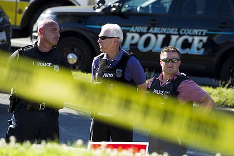 Police officers secure the area after multiple people were shot at an office building housing The Capital Gazette newspaper in Annapolis, Md. ( Photo | AP )