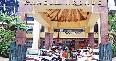 Police personnel at Raheja Arcade in Koramangala where the attack took place on Saturday; (left) the victim Kanhaiyalal Agarwal | Pushkar V