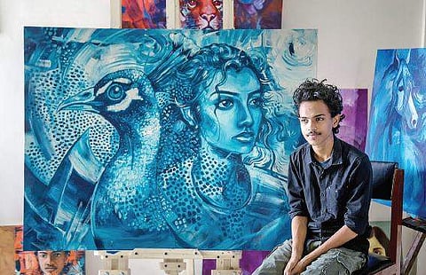 Minon John with his paintings