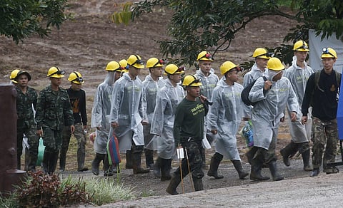 Rescuers walk toward the entrance to a cave complex where five were still trapped, in Mae Sai, Chiang Rai province, northern Thailand Tuesday, July 10, 2018. (Photo: AP)