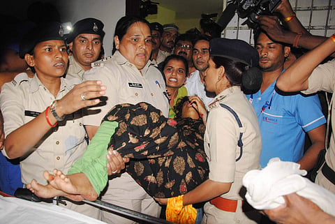 Police personnel rescue a woman who was kept in captivity by a youth for over 12 hrs in a residential flat in Bhopal on Friday July 13 2018. | PTI
