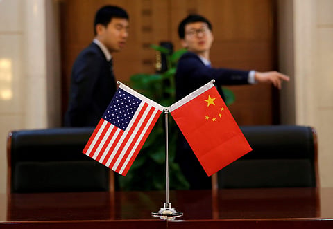 Chinese and U.S. flags are set up for a signing ceremony during a visit by U.S. Secretary of Transportation Elaine Chao at China's Ministry of Transport in Beijing, China April 27, 2018.  | Reuters