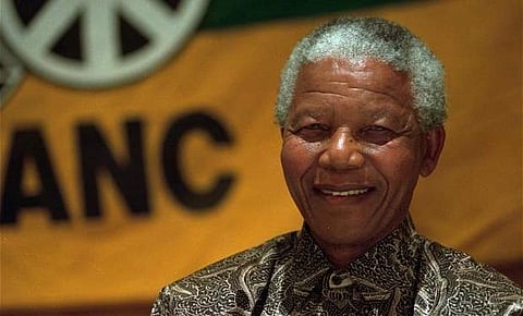 South Africa on Wednesday marked 100 years since Nelson Mandela's birth with a 'town hall' forum hosted by Barack Obama and a walk led by the anti-apartheid leader's widow among a series of tributes. (Photo | AP)