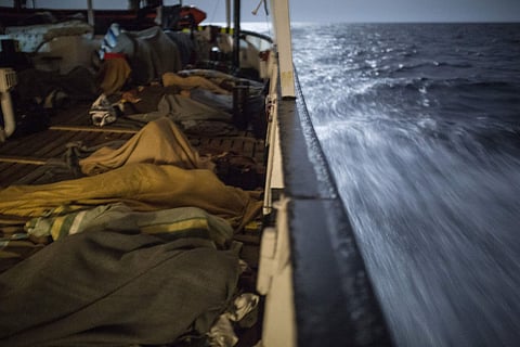 Migrants sleep aboard the Open Arms aid boat. (AP)