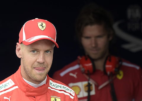 Ferrari driver Sebastian Vettel of Germany smiles after setting a pole position during the qualifying session at the Hockenheimring racetrack in Hockenheim. | AP