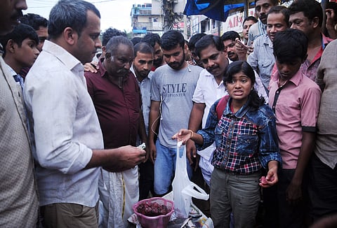 Hanan, a third year BSc Chemistry student, selling fish at Thammanam Junction. (Express Photo | A Sanesh)
