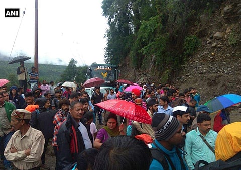 People stranded on National Highway 3 after boulders fall on the road near Manali; Restoration work underway. | ANI