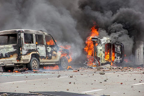 Flames rise from a burning vehicle as Maratha Kranti Morcha protesters clashed with police personnel during a protest called for reservations in jobs and education in Navi Mumbai on Wednesday July 25 2018. (Photo | PTI)