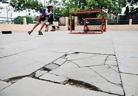 Children practicing on a skating rink that is chipped off at various places at  LB Stadium;