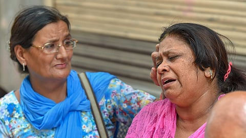 Relatives of the Bhatia family whose 11 members were found dead in their house on Sunday outside their house at Burari in New Delhi on July 3, 2018. (Photo | PTI)