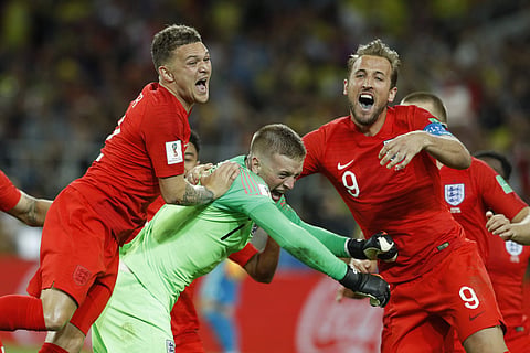 England's Harry Kane, right, goalkeeper Jordan Pickford, centre, and Kieran Trippier celebrate at the end of the round of 16 match between Colombia and England at the 2018 soccer World Cup in the Spartak Stadium, in Moscow, Russia, Tuesday, July 3, 2018. 