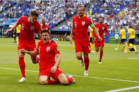 England's Harry Maguire celebrates with his teammates after scoring his side opening goal during the quarterfinal match between Sweden and England at the 2018 soccer World Cup in the Samara Arena, in Samara, Russia. | AP