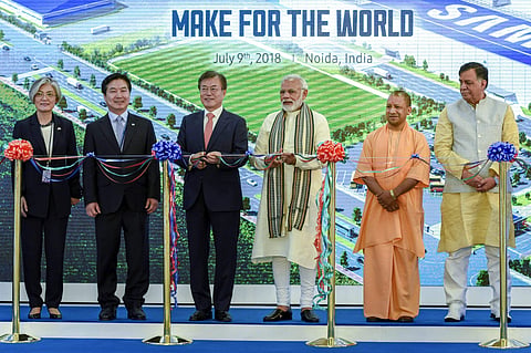 PM Narendra Modi with South Korean President Moon Jae-in and Uttar Pradesh CM Yogi Adityanath at the inauguration ceremony of world's largest mobile phone manufacturing facility in Noida. (Photo | PTI)