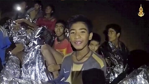 The brave boys smile at the camera inside the caves (Royal Thai Navy Facebook Page via AP, File)