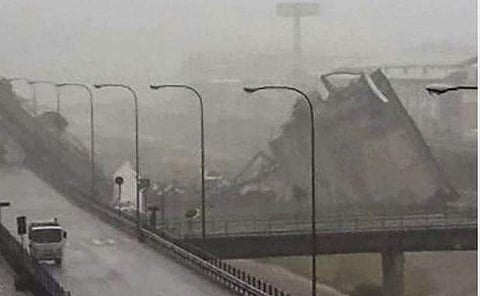 This handout picture provided by the Italian police (Polizia di Stato) on August 14, 2018 shows a collapsed section of a viaduct on the A10 motorway in Genoa. A section of a viaduct on the A10 motorway collapsed on August 14, 2018 in Genoa, Italian firefi
