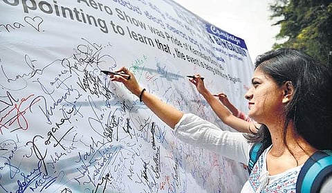 Students of Mount Carmel College participating in a signature campaign on Monday against the purported plan to shift Aero India 2019  | Pushkar V