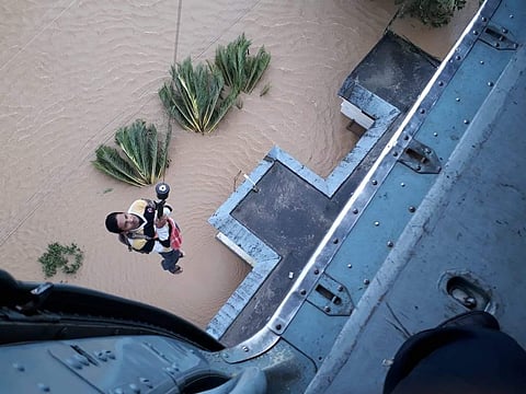 A photographer attempts to get an aerial shot of the flood situation in Pathanamthitta in Kerala. (Photo | Defence dept)