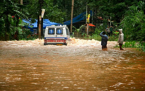 An ambulance passing through a flooded road at Kuttiyadi - Kozhikode stretch (Photo | EPS/TP Sooraj)