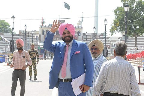 Former Indian cricketer-turned-politician and Punjab Cabinet Minister Navjot Singh Sidhu (C) gestures as he crosses the India Pakistan border in Wagah. (File | AFP)