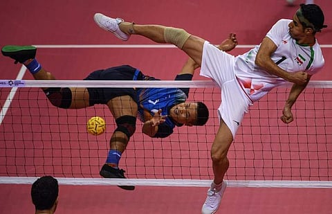 ndia's Thokchom Seitaram Singh (L) jumps for the ball against Iran's Jafari Mehrdad during the sepak takraw men's team regu match during the 2018 Asian Games | AFP