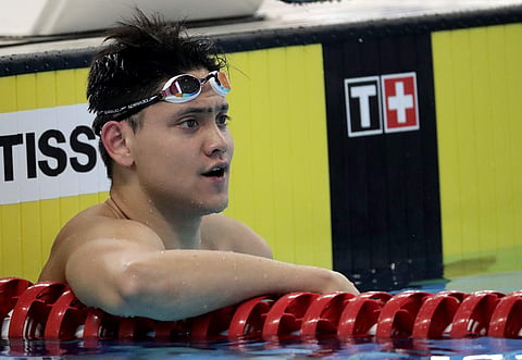 Singapore's Joseph Schooling reacts after his men's 50m butterfly heat during swimming competition at the 18th Asian Games in Jakarta, Indonesia, Thursday, Aug. 23, 2018. | AP