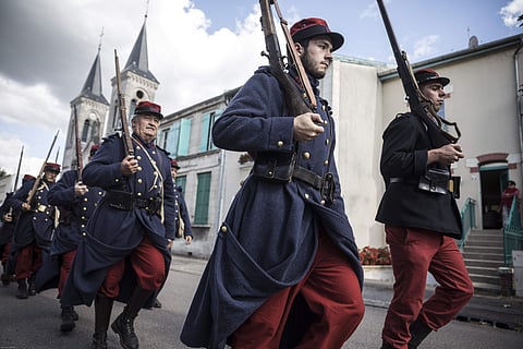 Men dressed in WWI uniforms march during a parade, part of the reconstruction of the WWI battle of Verdun, Saturday, Aug. 25, 2018, in Verdun, eastern France. (Photo | AP)
