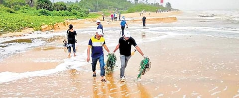 People clearing ghost nets along the Dakshina Kannada coastline