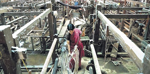 A worker engaged in cleaning the manufacturing unit of the Chendamangalam Handloom Weavers Cooperative Society in Kochi on Tuesday | Melton Antony