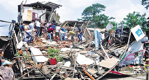 Fire force personnel and local residents are engaged in rescue operations after a three-storey building collapsed in Palakkad on Thursday | Express
