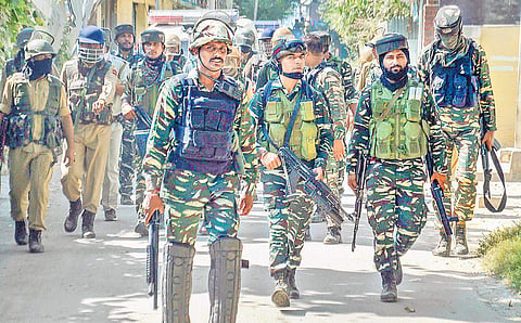 Security personnel take position near a house where militants were hiding during an encounter in which the top Hizbul Mujahideen militant, Altaf Ahmad Dar, and his associate Umar Rashid were killed, at Muniward in Anantnag district (Photo | PTI)