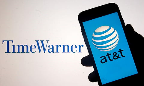 Smartphone with AT&T logo is seen in front of displayed Time Warner logo in this picture illustration taken June 13, 2018. (Photo | Reuters)