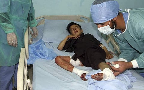 Doctors assist a wounded young man in a hospital after a deadly attack on a Shiite mosque in Gardez, the capital of Paktia. (Photo | AP)