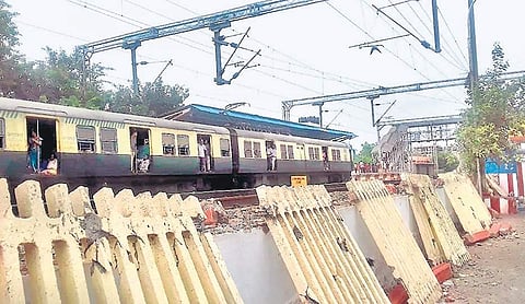 The concrete wall that separated the fourth railway line from the road at Palavanthangal railway station was demolished on Monday | Express