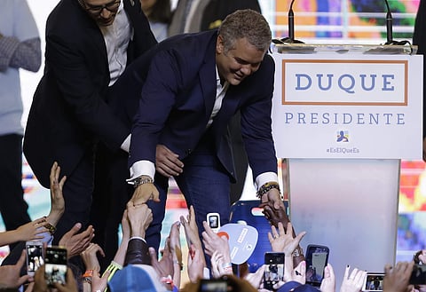President Ivan Duque shakes hands with supporters after his victory in the presidential runoff election in Bogota. (Photo| AP)