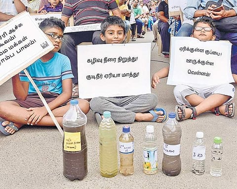 Residents of Chitalapakkam displaying bottles of contaminated ground water collected from the locality on Sunday | Martin Louis