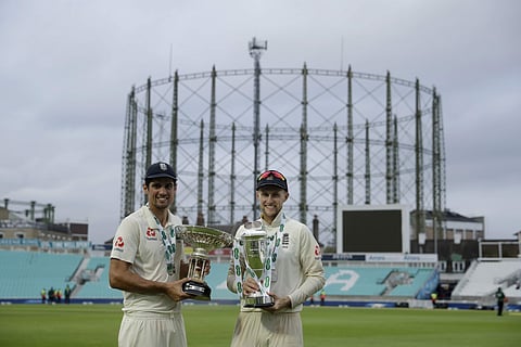 England's Alastair Cook, left, at the end of his last ever match before retiring from test cricket, and captain Joe Root pose for photographers after winning the fifth cricket test match and the five match series between England and India at the Oval cric
