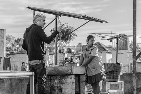 This image released by Netflix shows filmmaker Alfonso Cuaron on the set of 'Roma.' | Associated Press