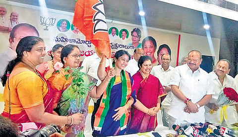 BJP Mahila Morcha State president Thota Vijayalakshmi waves party flag after taking charge,  in Vijayawada on Friday | EXPRESS