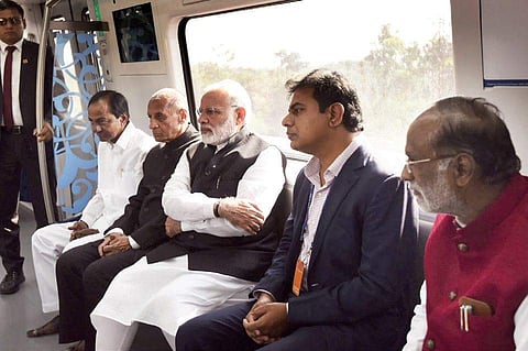 File image of PM Narendra Modi taking a ride along with Governor ESL Narasimhan, CM K Chandrasekhar Rao and minister KTR.