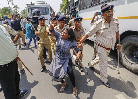 A Gujarat congress supporter being detained by Gandhinagar Police during 'Khedut Aakrosh rally' and 'Assembly gherao march' in Gandhinagar. (Photo| PTI)