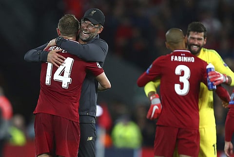 Liverpool's coach Juergen Klopp hugs Liverpool's Jordan Henderson after the Champions League Group C soccer match between Liverpool and Paris-Saint-Germain at Anfield stadium in Liverpool, England, Tuesday, Sept. 18, 2018.  | AP