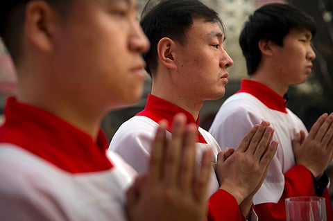 FILE - In this Saturday, March 31, 2018, file photo, Chinese acolytes pray during a Holy Saturday Mass on the evening before Easter at the Cathedral of the Immaculate Conception, a government-sanctioned Catholic church in Beijing. (Photo | AP)