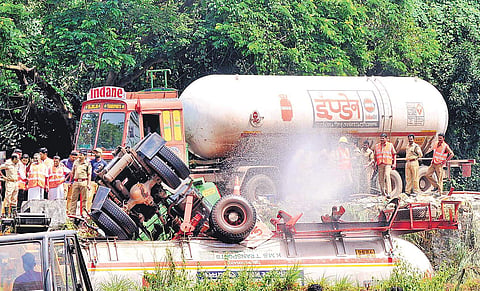 Fire and Rescue Services personnel spraying water on the LPG tanker which overturned at Panambra in Malappuram on Friday | Express