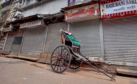 A hand pulled rickshaw stands in front of a closed market during 'Bangla Bandh' strike called by BJP against the State Government in Kolkata Wednesday Sept 26 2018. | PTI