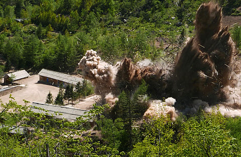 Smoke and debris rise in the air as barracks buildings for guards and tunneling workers at North Korea's nuclear test site are blown up at Punggye-ri of the country's North Hamgyong Province. (Photo | AP)