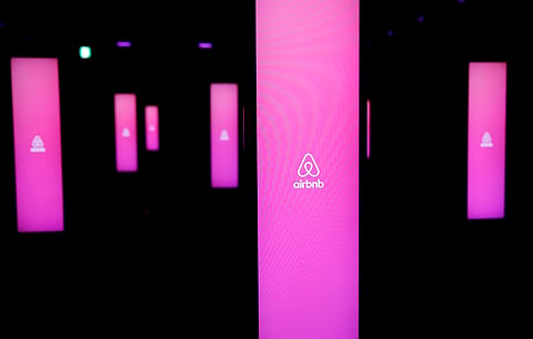 The logos of Airbnb are displayed at an Airbnb event in Tokyo. (Photo | Reuters)