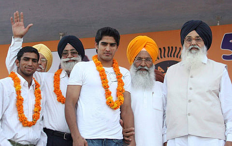 Former Chief Minister Parkash Singh Badal (L) and Sukhdev Singh Dhindsa (2nd L) felicitate boxers Vijender and Jitender Kumar during the inaugural session of 55th Senior Mens National Boxing Champianship 2008 in Bathinda. (File | PTI)
